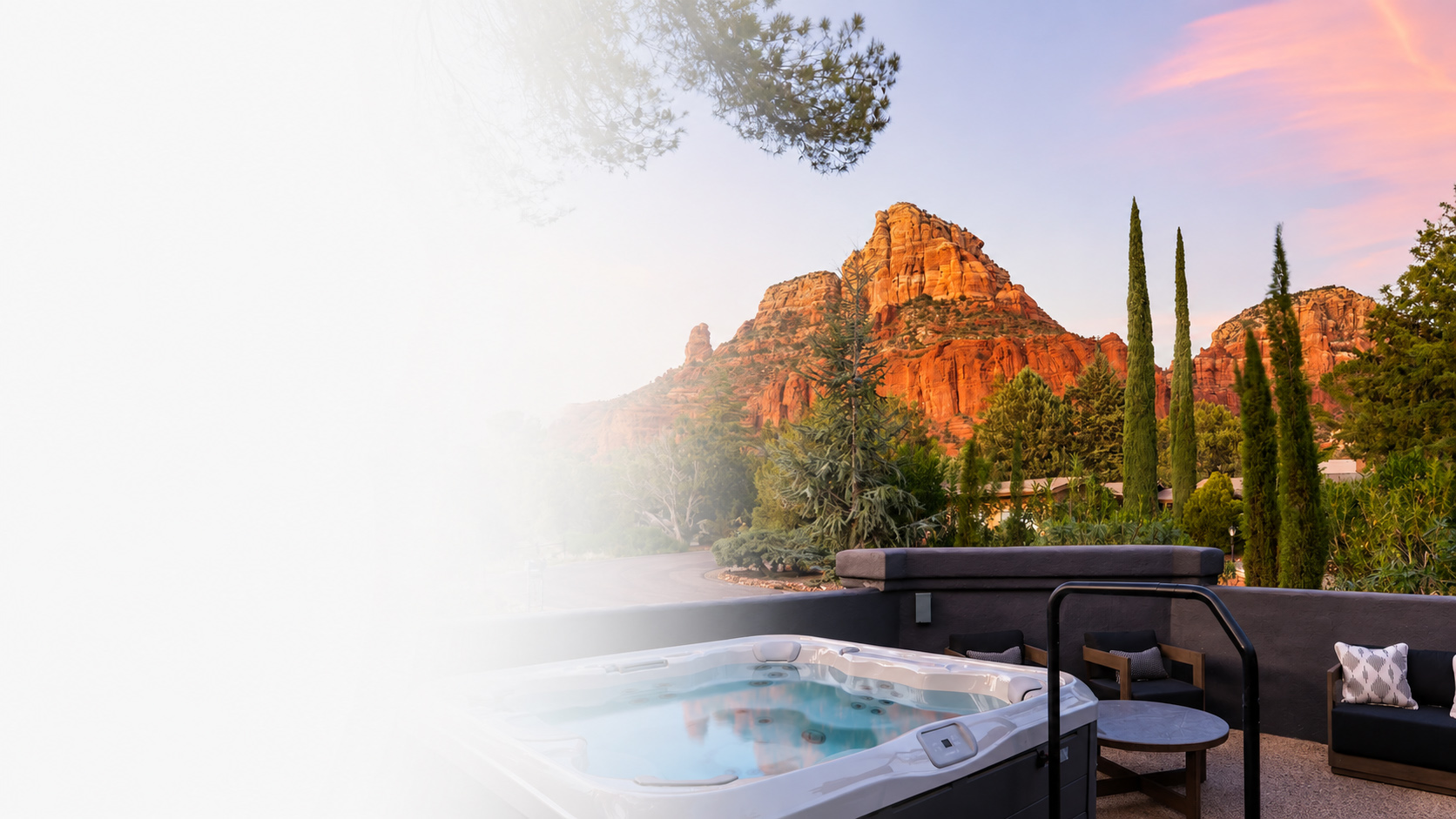 Hot tub overlooking red rock mountains at sunset